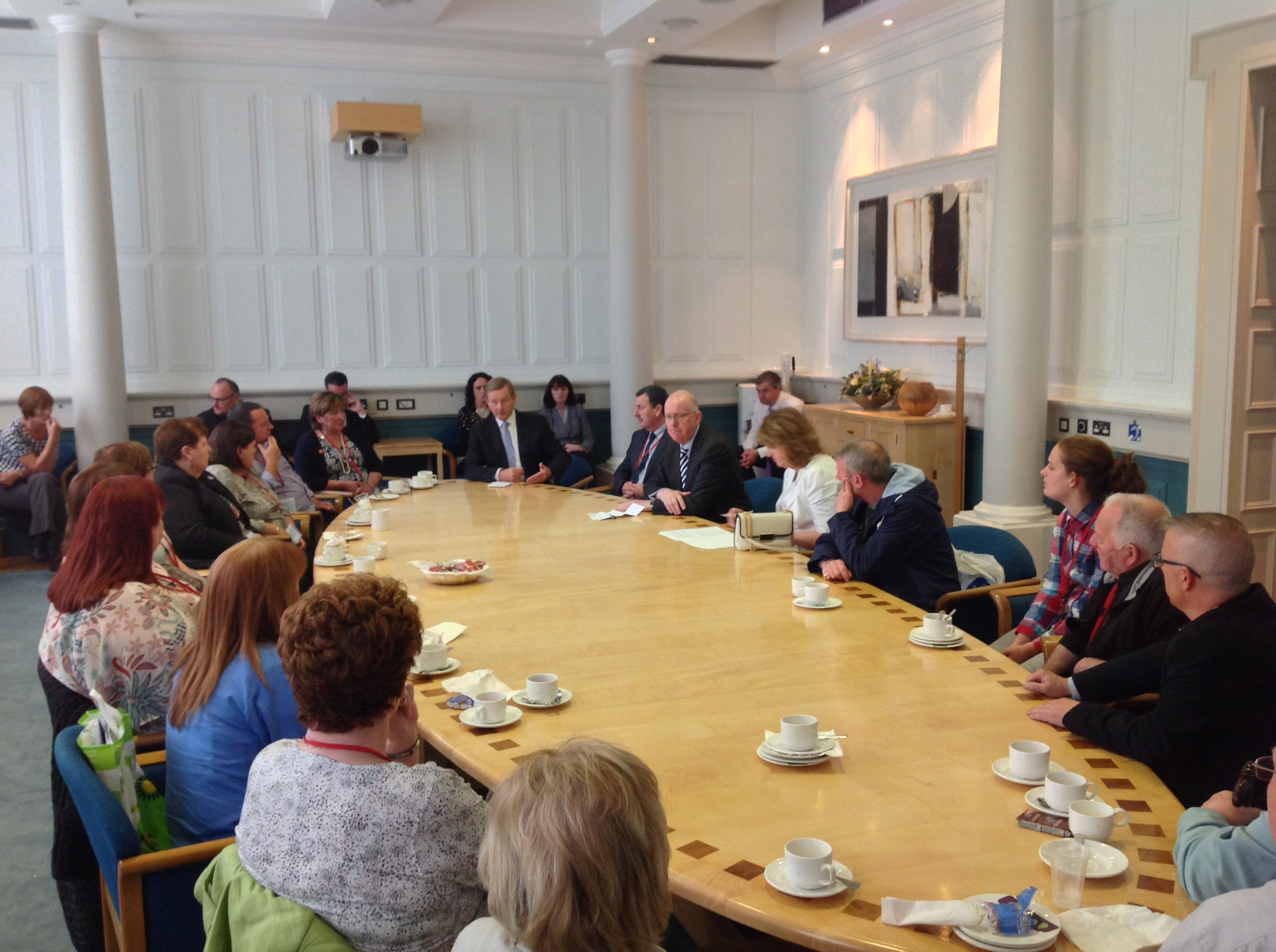 Taoiseach Enda Kenny, Tánaiste Joan Burton and Foreign Affairs Minister Charlie Flanagan around the table with the Ballymurphy families