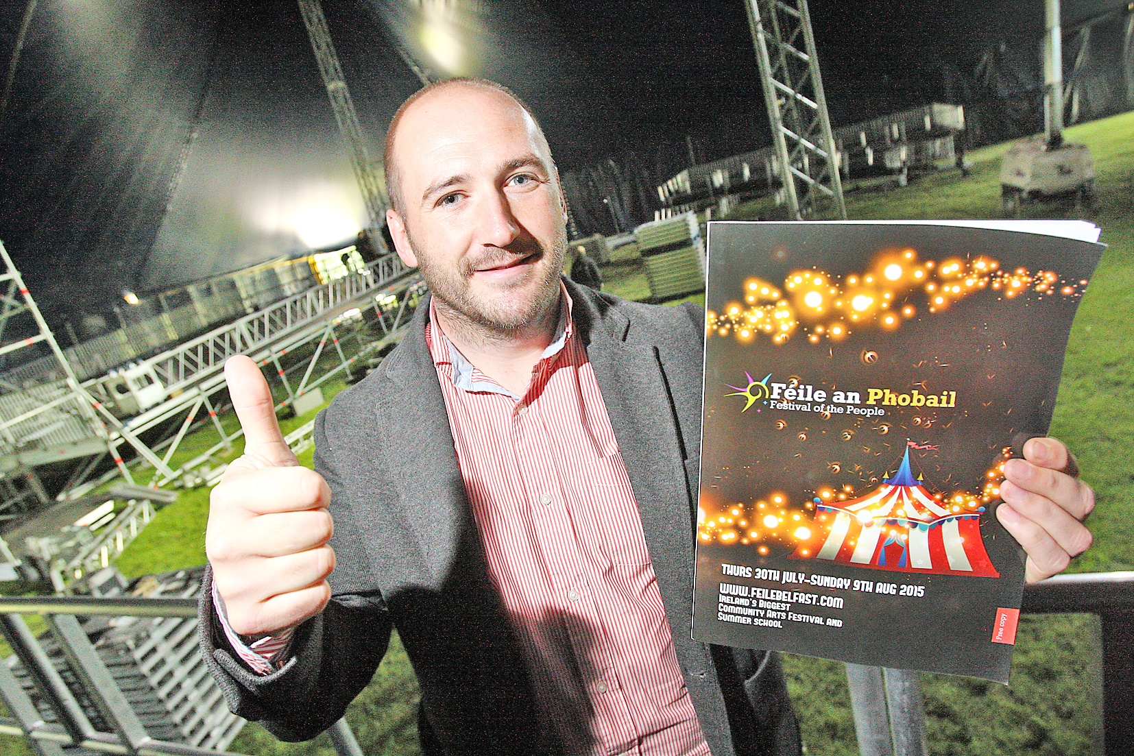 Director of Feile an Phobail, Kevin Gamble, inside the Big Top with his Féile programme