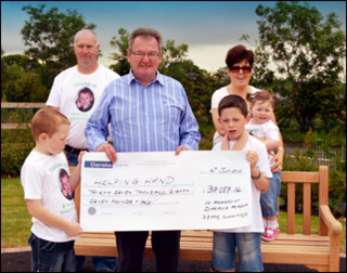 The Frazer family with the cheque