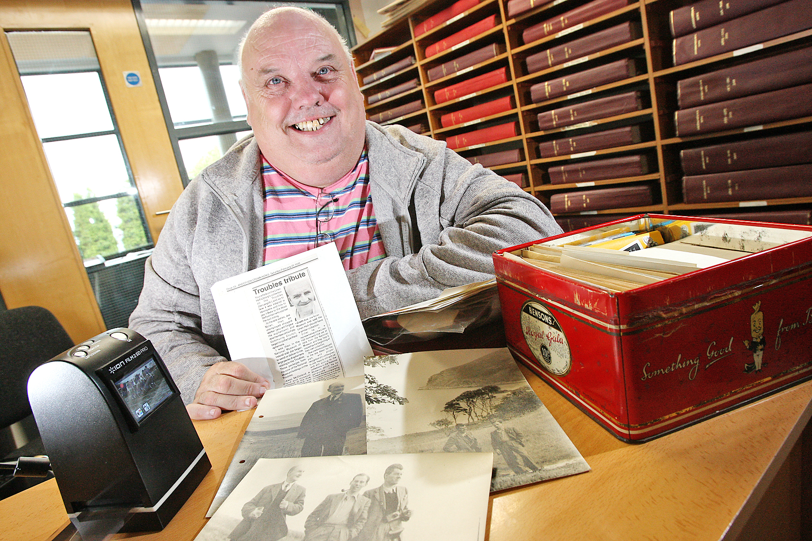 James McCabe examines some of Joe Nolan’s extensive archive; he’s holding a picture of the poet and archivist 