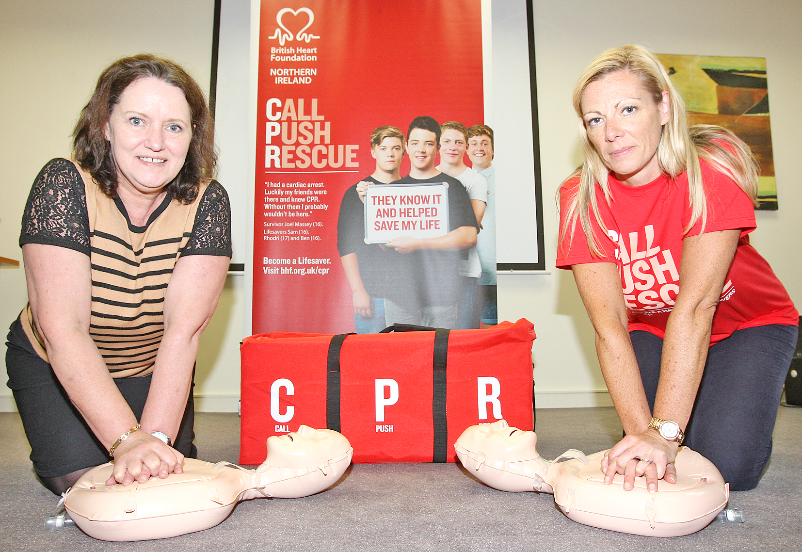Cardiac arrest survivor Lynda Donaldson (left) with Stephanie Leckey of the British Heart Foundation NI demonstrating life-saving CPR techniques