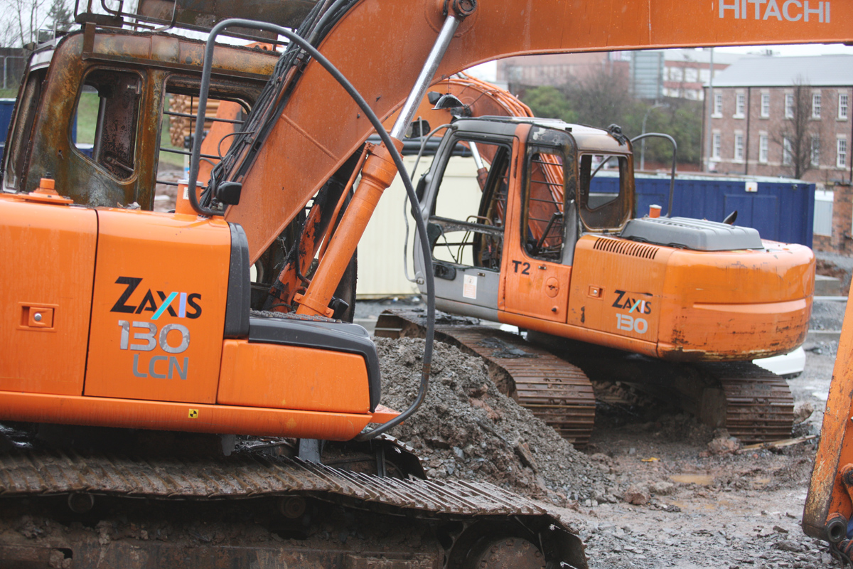 Burnt-out diggers at a North Queen street housing development – one of several sites where work has ceased after AAD extortion demands