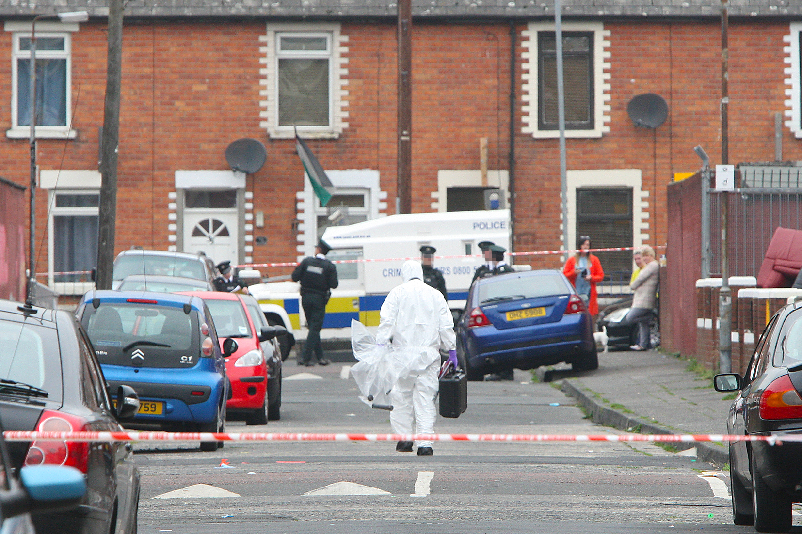 A police forensics officer removes the pipe-bomb device from the scene of yesterday’s alert in Rodney Drive