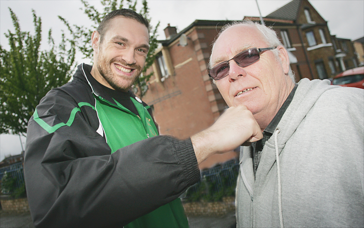 New world heavyweight champion Tyson Fury with Carrick Hill community worker Frank Dempsey during his 2012 visit
