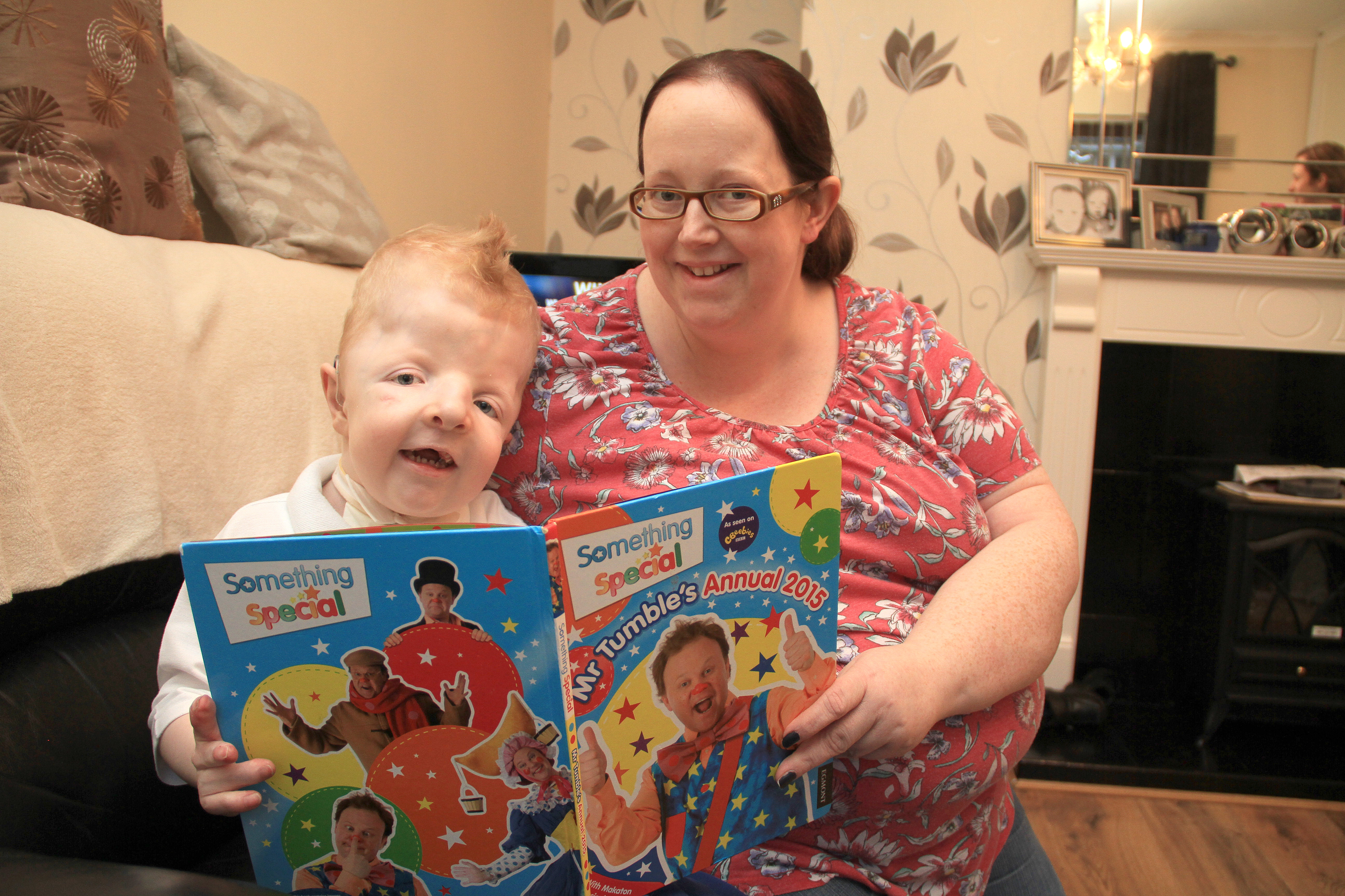 Dáire at home with his mum Colette – she’s urging the public to run or walk the Belfast Marathon in aid of Mencap