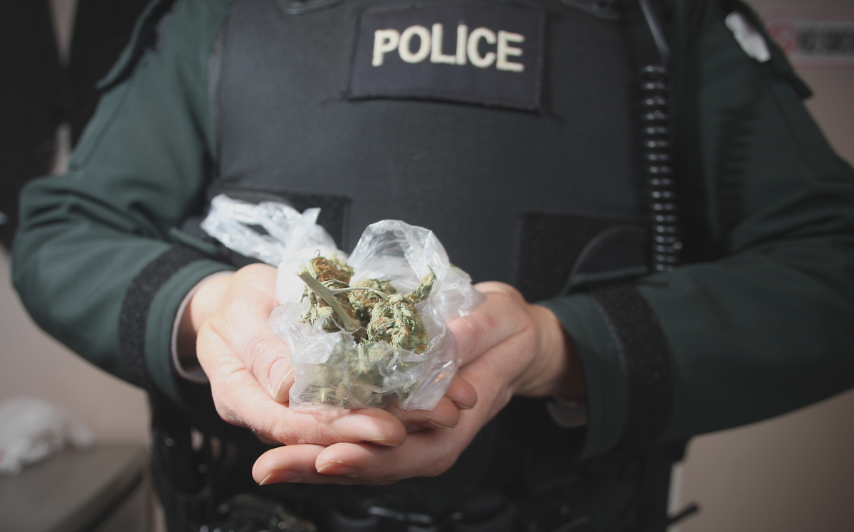 A PSNI officer holds a quantity of herbal cannabis that was handed over to an Oldpark community worker on Monday