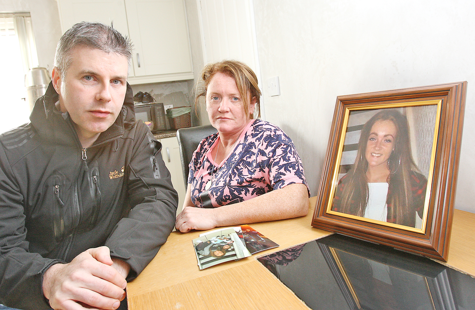 Noreen Lavery and Cllr Stevie Corr with family photos of Caoimhe, a mother-of-two who took her own life aged 21 after battling mental illness