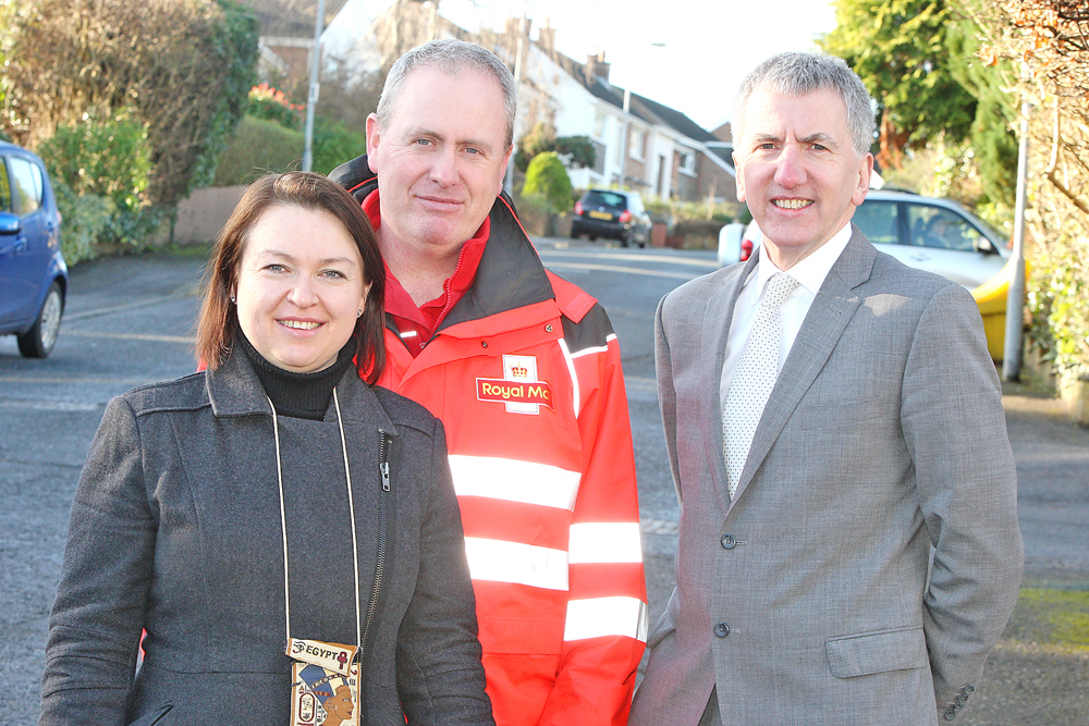 Postman Dermot McCabe with Deborah Beladi, the woman whose life he saved while out on his daily walk in and around Finaghy Road South, and South Belfast MLA Máirtín Ó Muilleoir