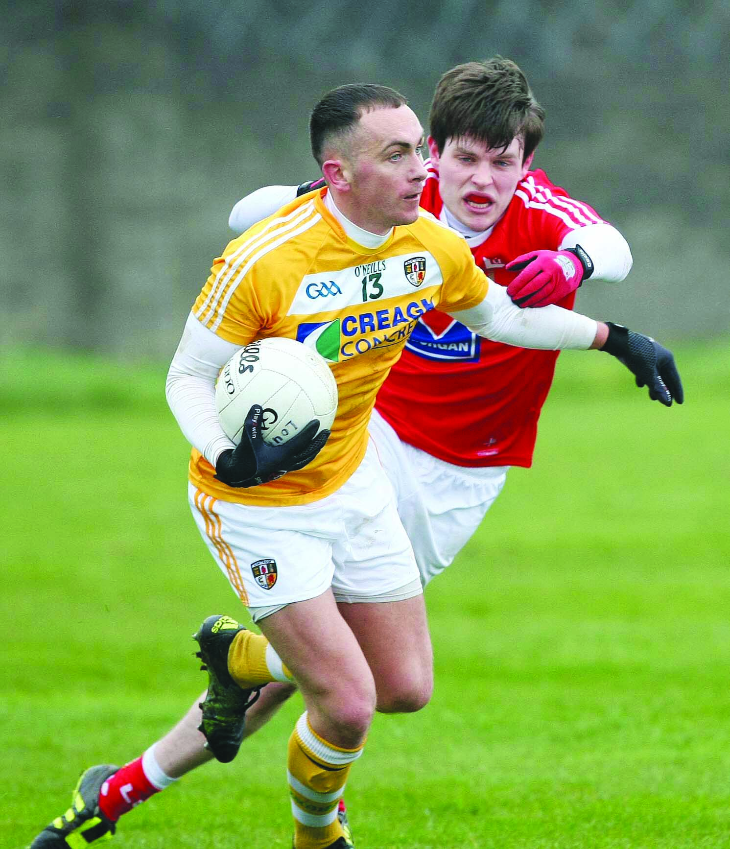 Brian Neeson breaks a tackle during Antrim\'s draw with Louth on Sunday. The sides meet again at Croke Park on April 23