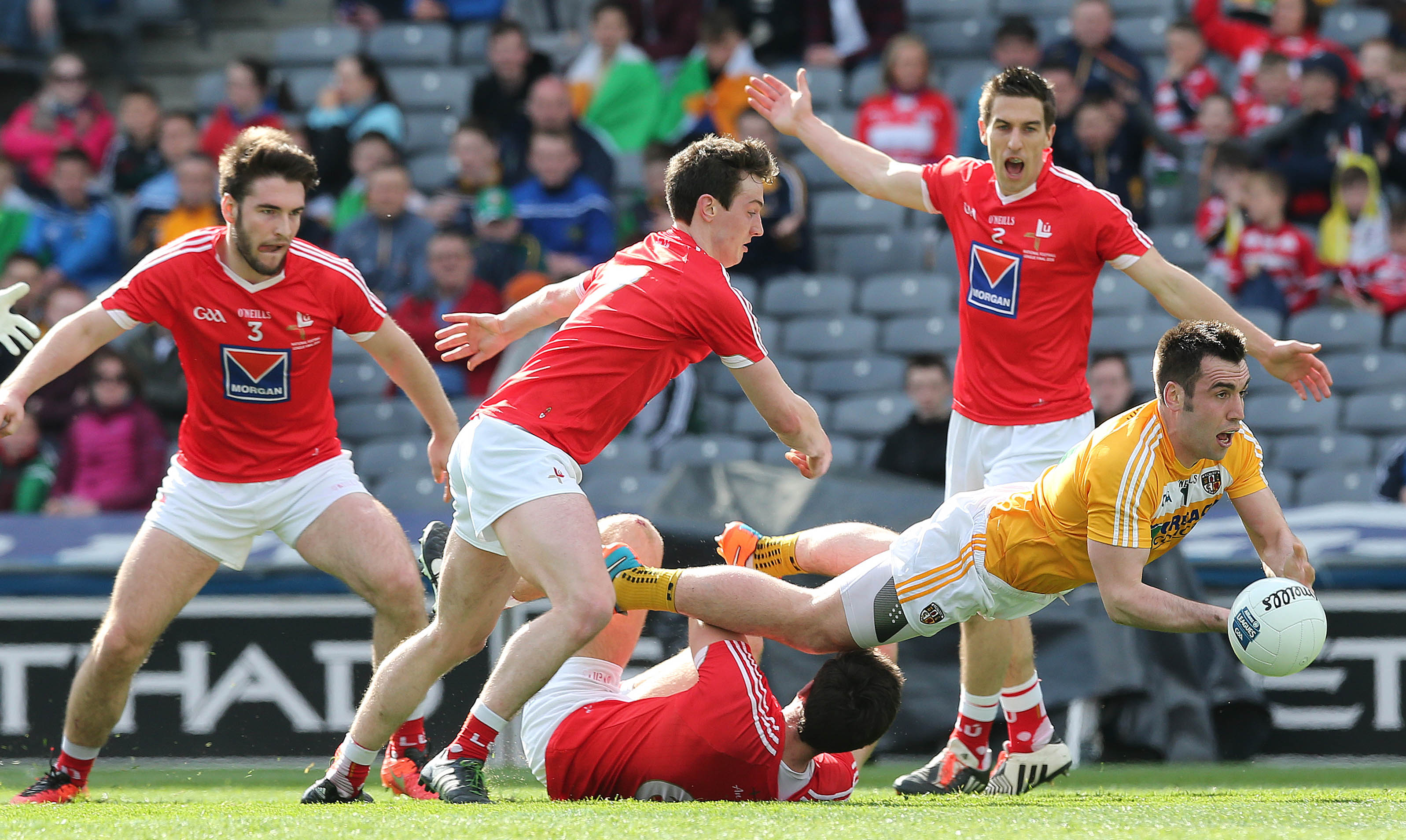 Antrim’s Kevin Niblock gets the ball away under pressure during Saturday’s Division Four final defeat to Louth at Croke Park