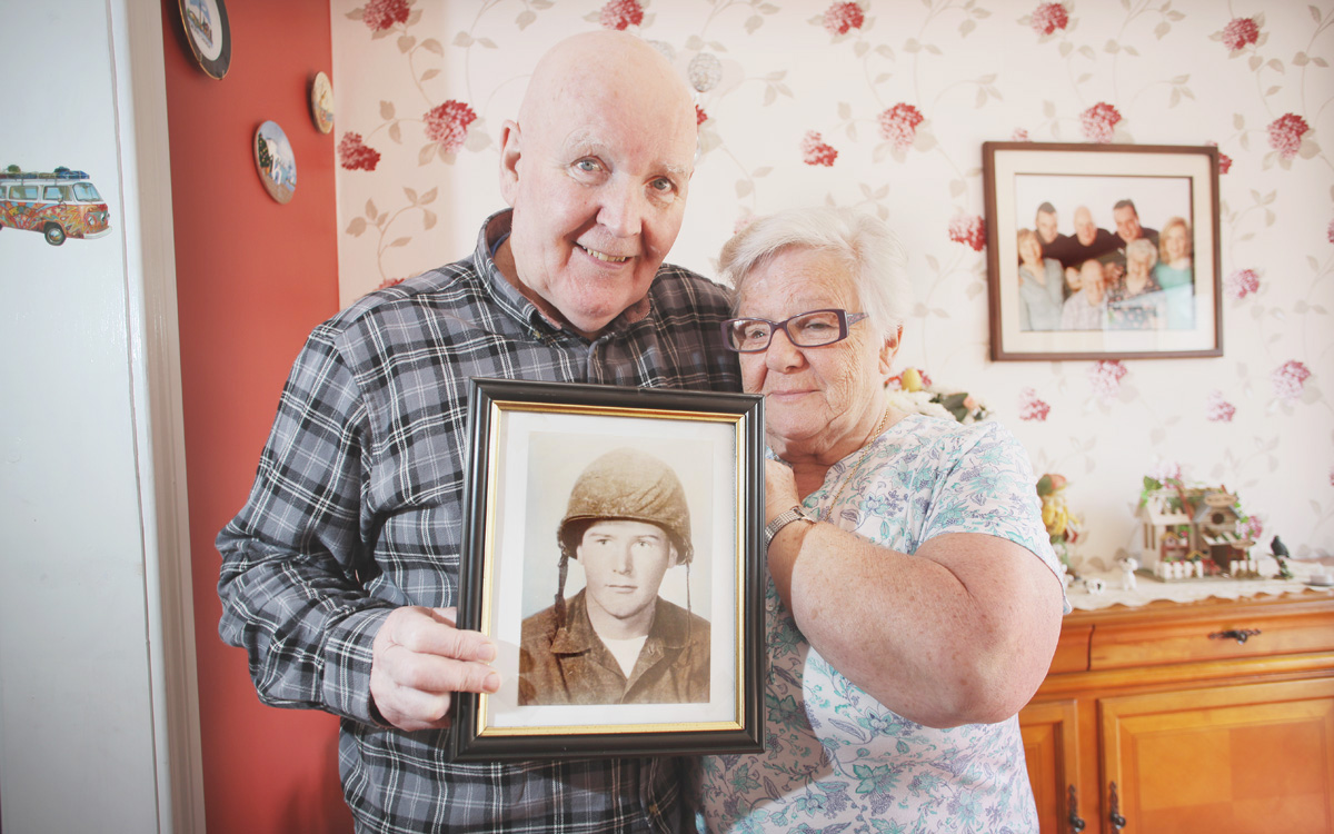 Billy & Bridie Brown stand with picture of Harry Brown who passed away last month