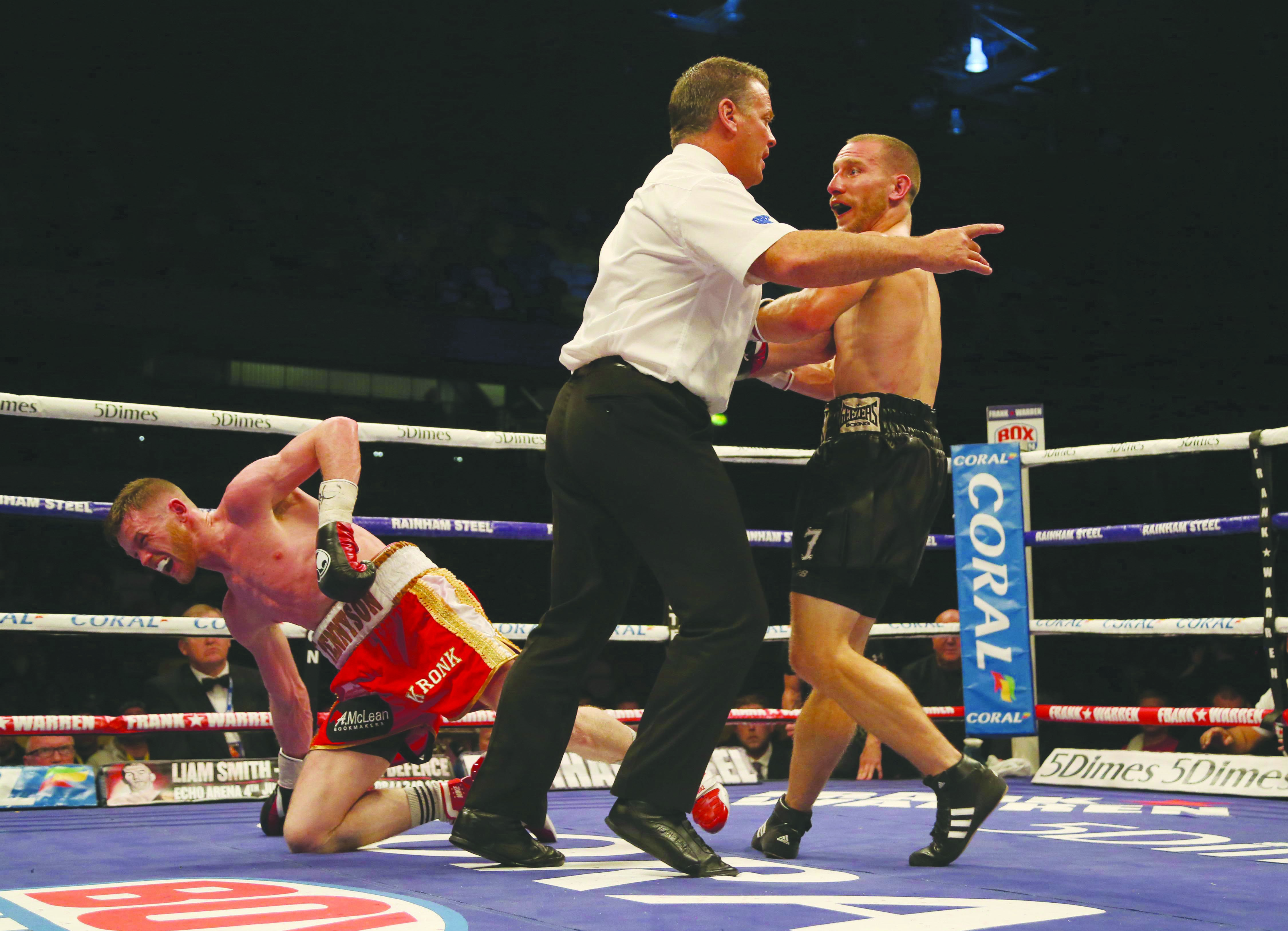 Referee Michael Alexander sends Ryan Walsh to a neutral corner after he landed the body shot that shattered James Tennyson’s hopes of winning the British featherweight title on Saturday\nPicture by Jed Leicester /Press Eye