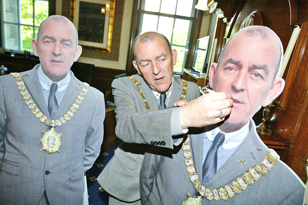 Arder Carson’s last day as Lord Mayor of Belfast yesterday with two cardboard cut-outs of himself from his May Day picnic at City Hall