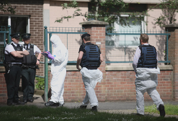 Police and British army bomb disposal experts at the scene of the find in the New Lodge\n\n