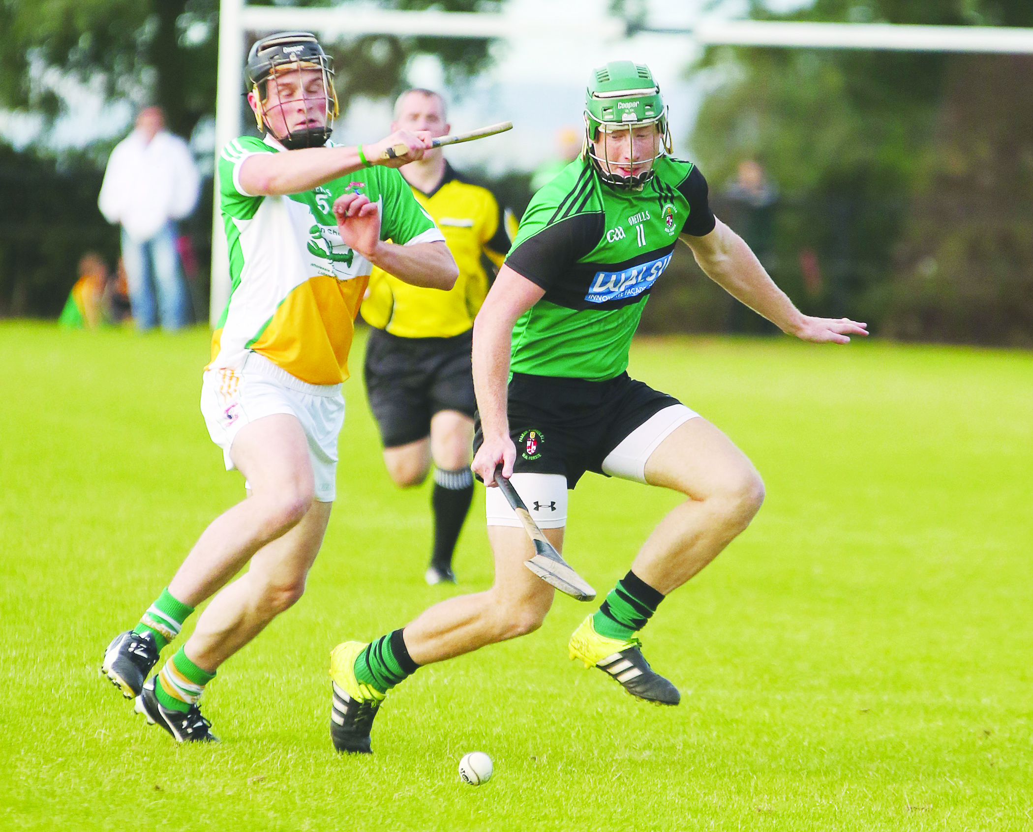 Sarsfield’s attacker Niall McKenna battles for possession with Glenariffe defender Conor Patterson during last Saturday’s IHC clash in Ahoghill 