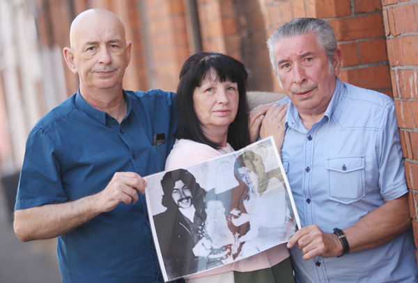 Paddy, Esther and Hugh Dempsey with a treasured portrait at the family home in Hillman Street
