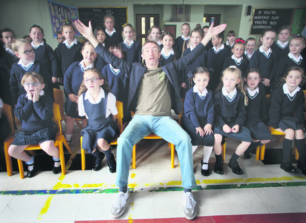 Conductor David Brophy with pupils from Our Lady’s Girls’ Primary School during a visit before his Titanic performance