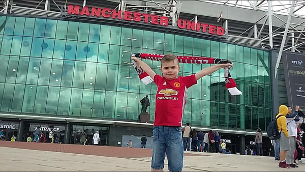 FOOTBALL FAN: Nine-year-old Sean McKinney outside Old Trafford in Manchester