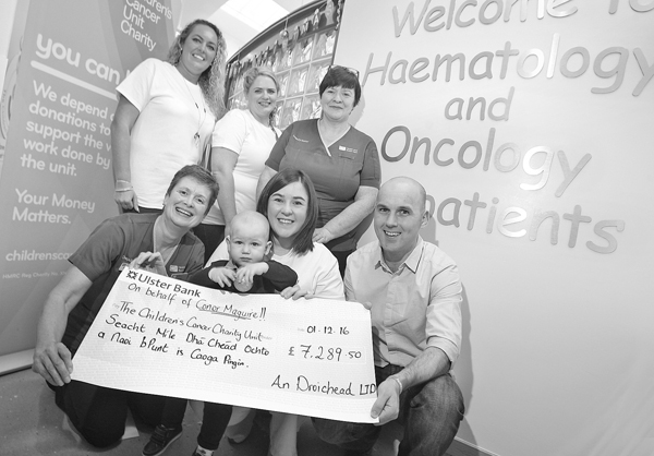 GENEROUS GESTURE: Seaneen O\'Loan and Tara Gibney from An Droichead with Catherine, Ciaran and their son Conor presenting deputy ward sisters Patricia Fleck and Gail Burns of the Haematology and Oncology Unit in the Children\'s Hospital with a cheque for £7289.50