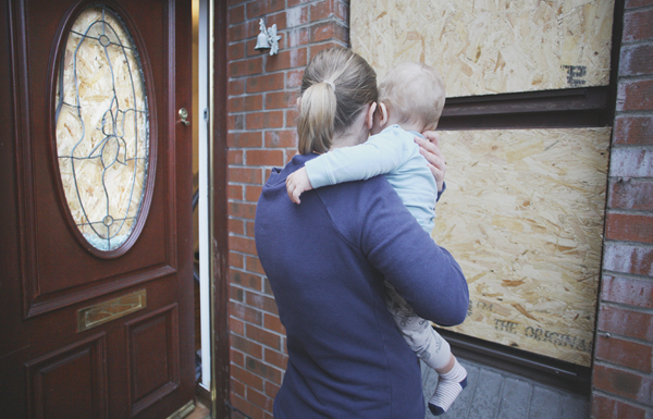 Sylwia Rossa-Orlowska outside her Downview home with her baby son after the racist attack