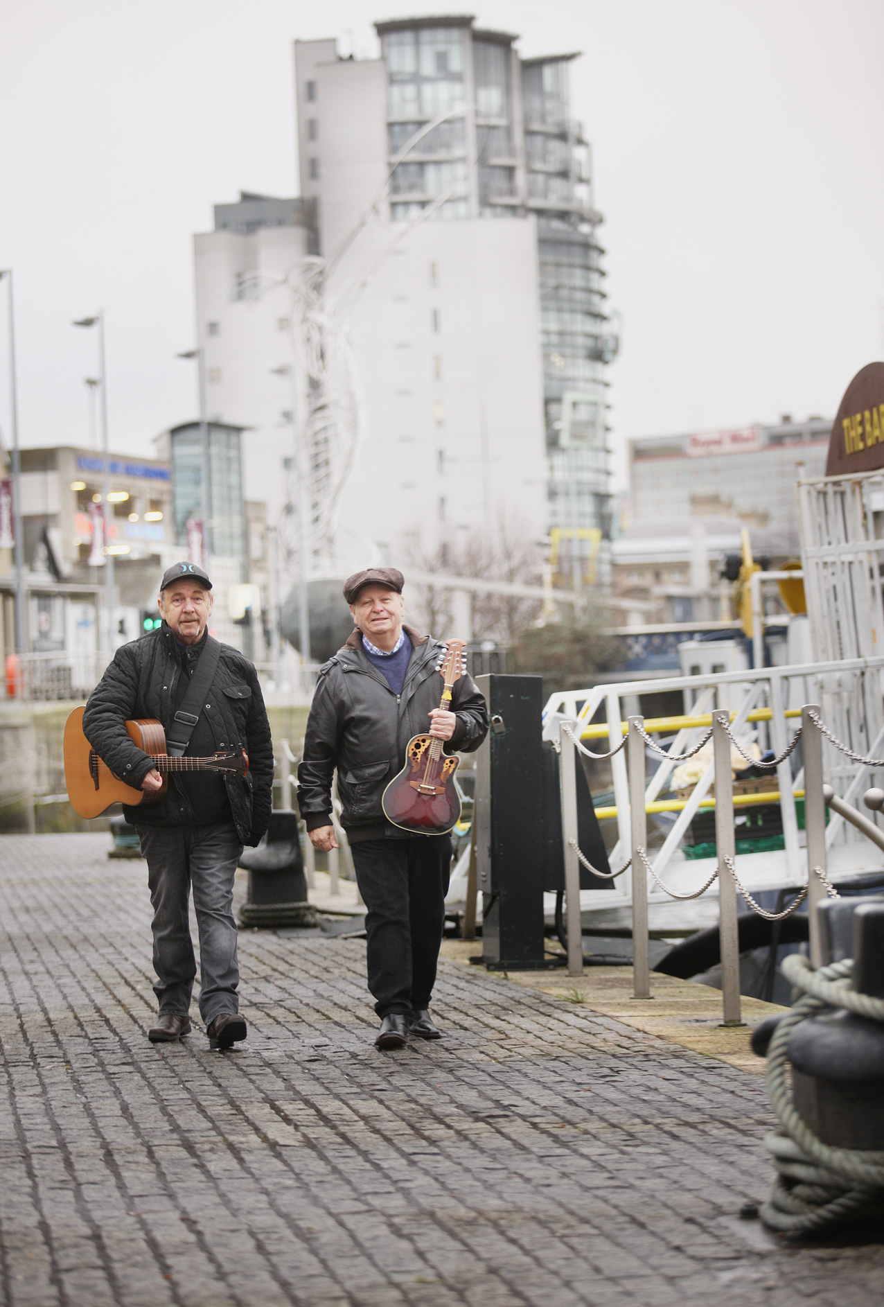Eddie and George Furey walk along the Lagan in Belfast city centre 