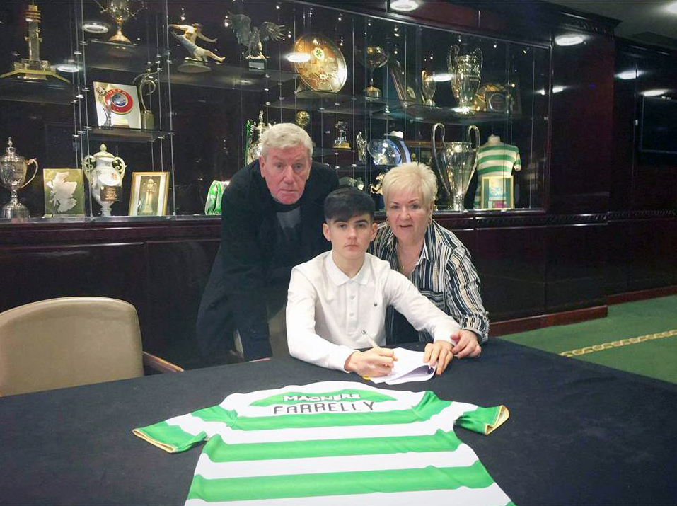 NAME ON THE SHIRT: Connor with his grandparents Rosaleen and Eamon Henry signing for Celtic in the Parkhead trophy room