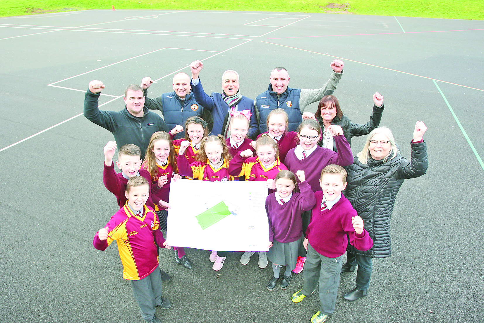 With new 4G pitch plans at Holy Trinity Primary School are Holy Trinity pupils with their principal Fiona Boyd, local politicians, Janice Austin and Pat Sheehan with Sean Nolan, Danny O\'Neill and Seamus Corr of Gort na Móna GAC