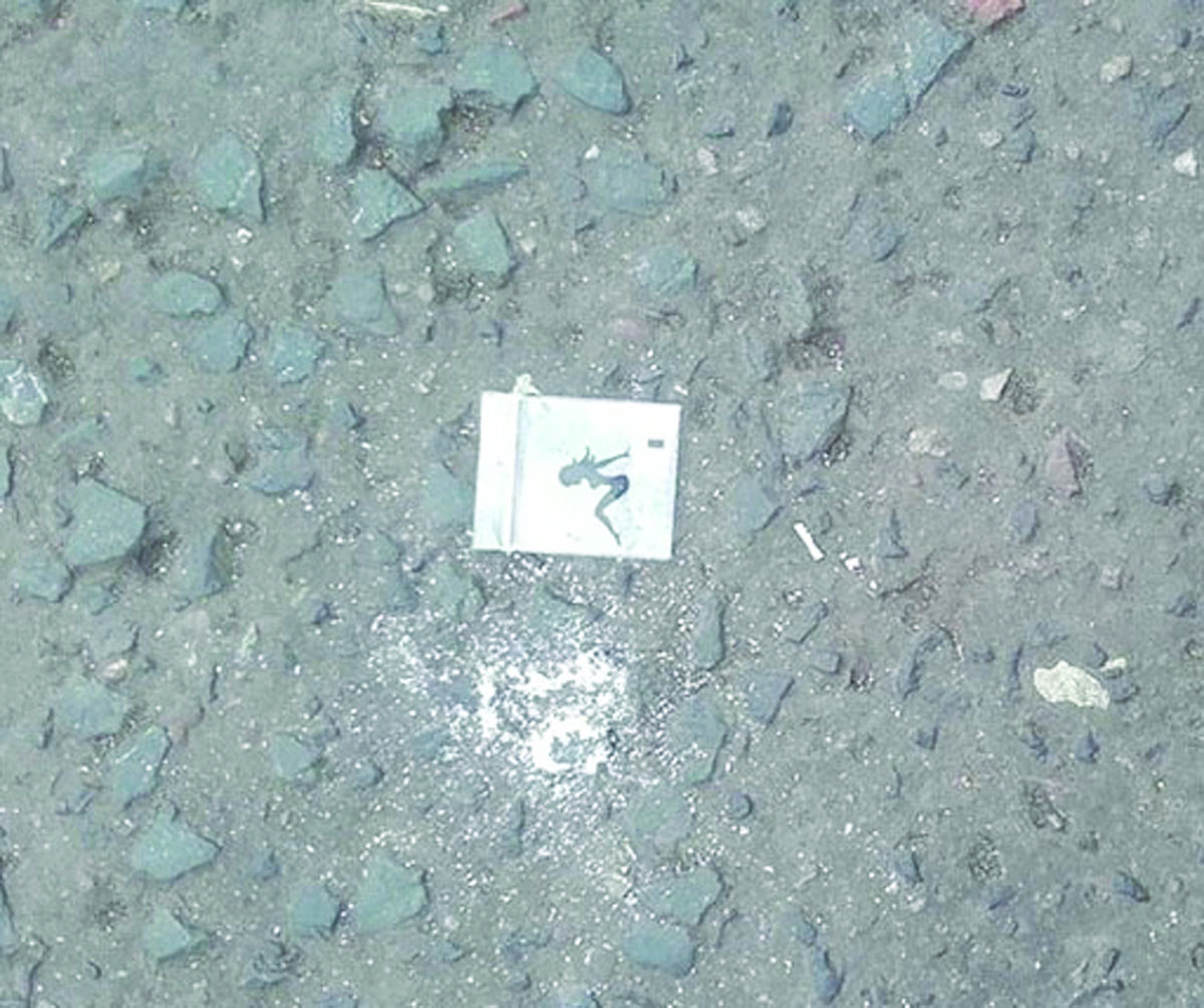 DANGER: A bag lies on the street with powder spilling from it