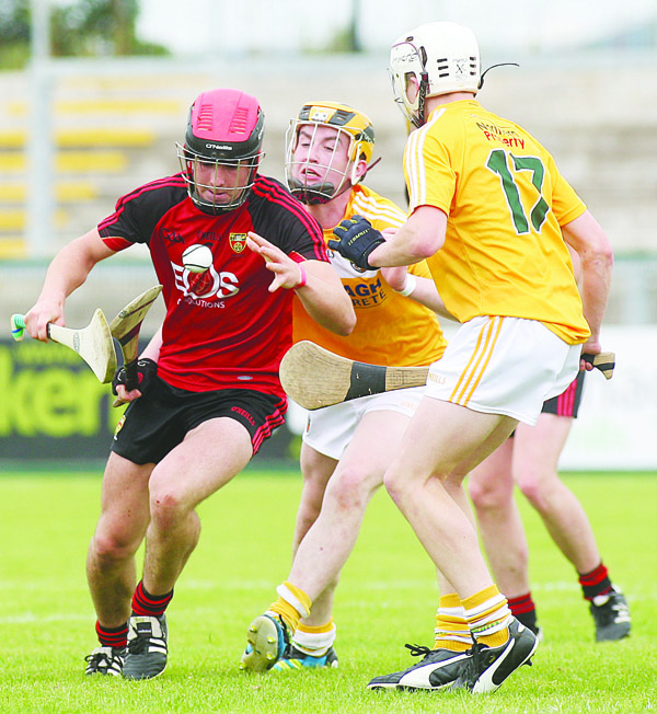 Antrim\'s Conor Boyd and Ed McQuillan challenge Down\'s Ruairi McCrickard during last year’s Ulster MHC final in Owenbeg. The Antrim duo are expected to feature for Collie Murphy’s side at Corrigan Park on Sunday when they host the Ardsmen