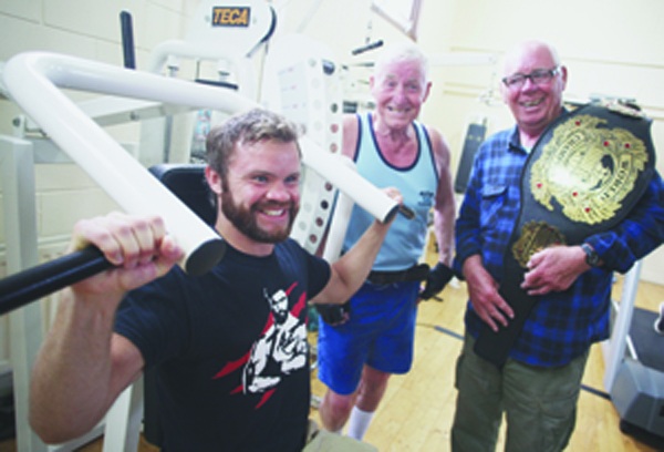 WORLD CHAMP: Andy Young with John and Frank Dempsey at the Carrick Hill gym where he arrived to promote a healthy lifestyle 