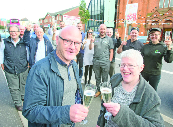 RAISING A GLASS: West Belfast MP Paul Maskey, chair of Fáilte Feirste Thiar, with Claire Hackett, secretary of the Fáilte Feirste Thiar, celebrating with local tourism providers after figures show West Belfast has had an amazing success in attracting visitors in 2017