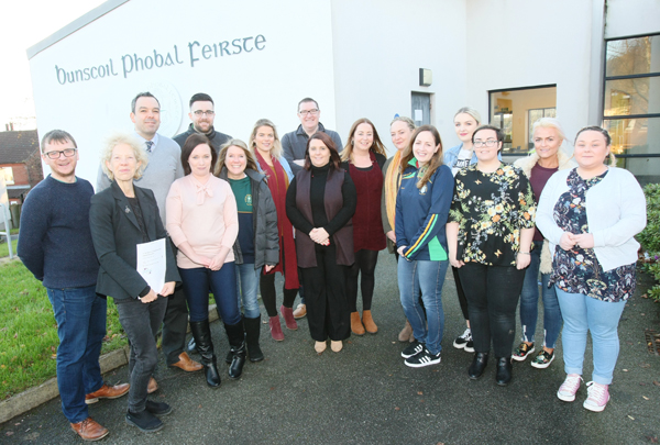 MAITH SIBH: Janet Muller from Pobal, second left, with ex-pupils from Irish medium schools who are now staff members at Bunscoil Phobal Feirste on the Shaws Road