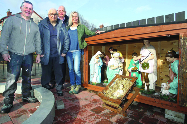 FESTIVE FEELING: Colm Denvir (left) and Seamus Kelly from Bawnmore Community Association with John Read from the Housing Executive and artist Janet Crymble at the nativity scene in Bawnmore, restored with help from a £3,000 grant from the Housing Executive