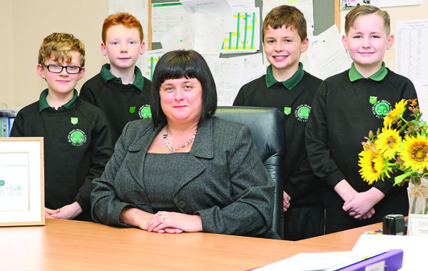 IN THE BIG CHAIR: New Principal of Sacred Heart Boys Primary School, Joanne Smyth, with P7 pupils Tairdelbach McCarthy, Anthony Kelly, Korey Hamill and Riley Owens