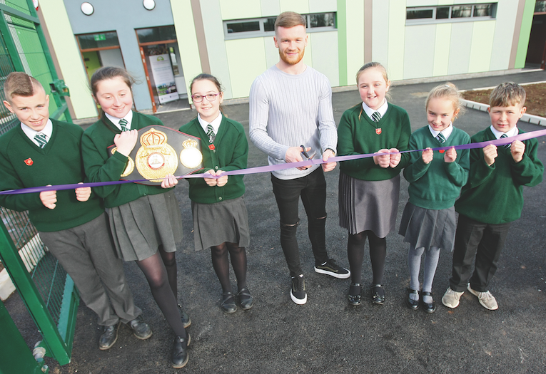 St Kieran’s Primary School pupils Shay Fox, Casey McKeaveney, Chanel Quinn, Niamh Willoughby, Chelsea Fennel and Patrick Robinson, with boxing champion James Tennyson, opening the new changing rooms at Sally Gardens\n