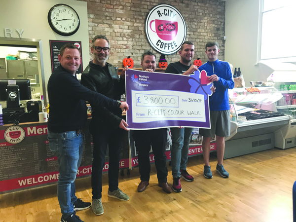 Michael Nugent, Regional Fundraiser from NI Children’s Hospice, receiving the cheque of £3800 from representatives of The Wall Group and R City at The Houben Centre
