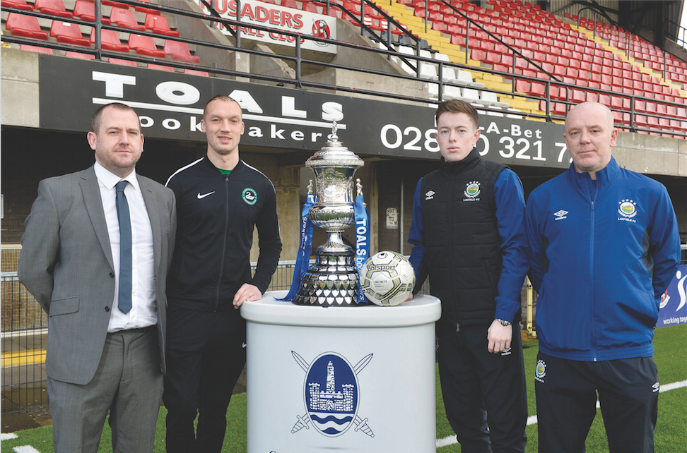 Newington manager Conor Crossan pictured with goalkeeper Dean Smyth, Linfield Swifts goalkeeper Alex Moore and Linfield Swifts boss David Dorian and the Steel and Sons Cup ahead of the Christmas Day decider at Seaview
