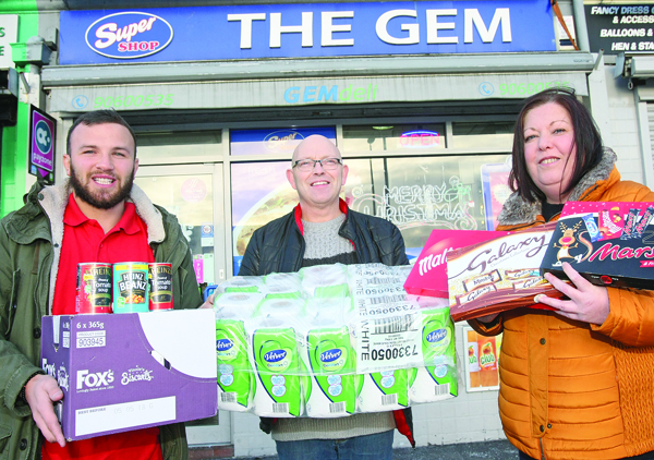 SEASON’S GREETING: Daniele Cacace and Larry Drumm of Andersonstown’s best-known newsagents The Gem and Jacqueline O’Donnell of the Andersonstown News. Larry has generously donated food items for the appeal.
