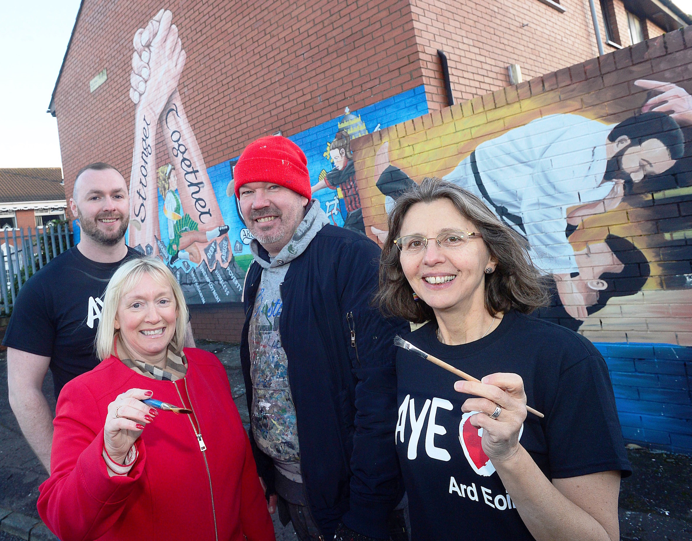 GREAT WORK: Seán Breen (Ardoyne Youth Enterprises Youth Engagement Officer), Amanda Ashe (Housing Executive Community Cohesion Officer), artist Michael Doherty and Catherine Couvert (Ardoyne Youth Enterprise Communications Officer) at the new mural in Havana Court in Ardoyne