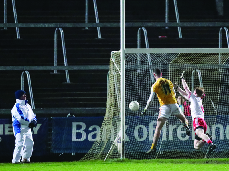 Antrim’s Matthew Fitzpatrick beats Tyrone’s Hugh Pat McGeary to the ball to score his side’s second goal during their 4-20 to 2-11 defeat to the Red Hands in their Dr McKenna Cup opener at the Athletic Grounds last night 