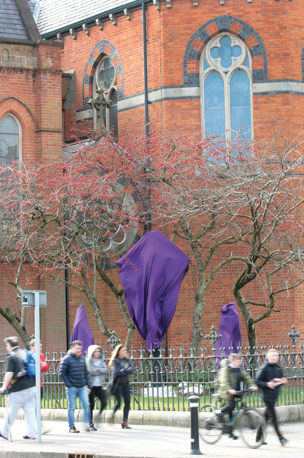 Statues outside St Paul\'s church on the Falls Road draped in purple cloth for the Lent tradition of Passiontide- the period between the fifth Sunday of Lent and Good Friday