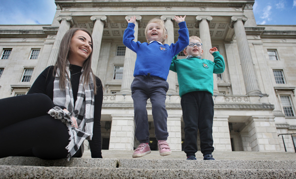 Nursery teacher Erin O’Reilly with Amelia Skillen and Ethan Huddleston from Stanhope Street nursery school on the steps of Parliament Buildings Stormont. The North Belfast nursery received a Derrytrasna Award for outstanding pastoral care from the Department of Education and Public Health Agency