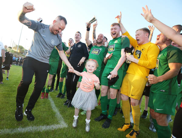 Lucky mascot Anna Murphy celebrates with Crumlin Star players after the North Belfast outfit won the Clarence Cup on Tuesday night following a 3-0 victory against Sirocco Works at Breda Park