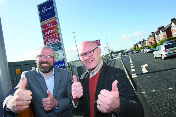 Kennedy Centre manager John Jones and West Belfast MP Paul Maskey show a thumbs up as roadworks come to an end