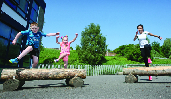 Ireland 400-metre hurdler Christine McMahon on a visit to St Paul\'s Primary School to talk to the teachers and pupils about the benefits and opportunities of participating in sport\nP6 pupils, Daryl Walsh and Aoife Magill give hurdling a go with Christine McMahon.