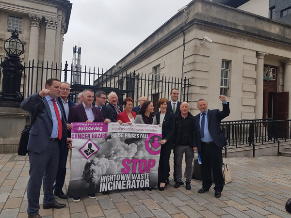 Caption: Campaigners from NoArc21 and local politicians celebrate the ruling outside Belfast High Court on Monday