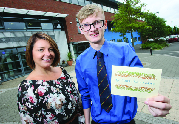 De La Salle teacher Nuala McCabe with sixth form pupil Barry O’Connor holding the thank you card he received from the family of the woman he helped
