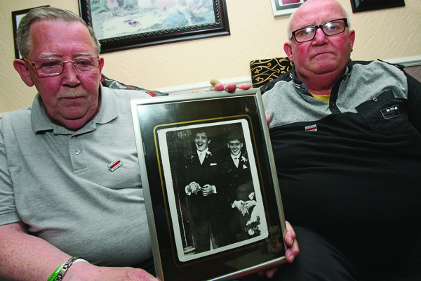 Liam and Pat Quinn hold a photo of their beloved brother Frank who was shot dead in 1971