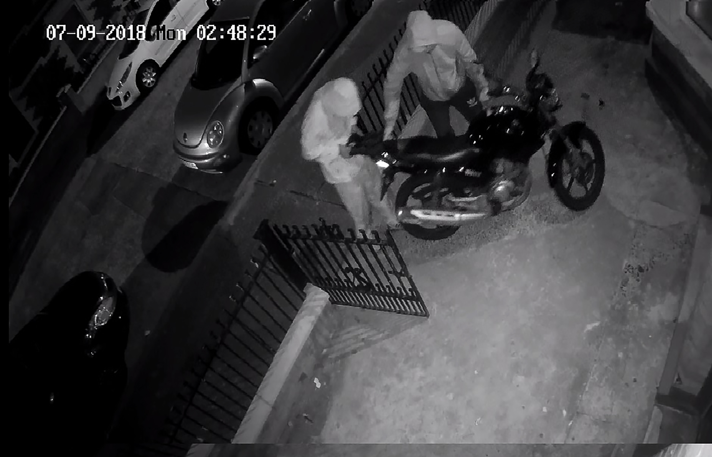 The thieves caught on CCTV taking bolt cutters to the motorcycle’s padlock