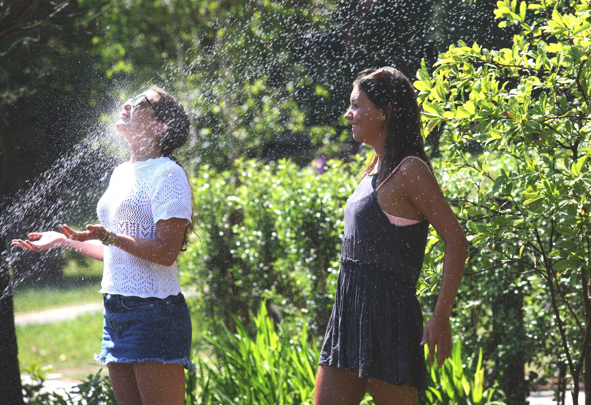 BOTANIC BAKES: Friends Mollie McLernon and Amy Cheevers grab a chance to cool off as temperatures in Botanic Park soared
